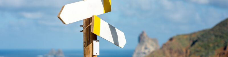Wooden road sign with empty boards