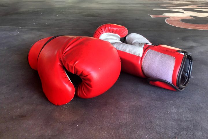 Red boxing gloves on floor