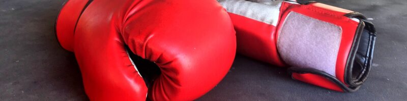 Red boxing gloves on floor