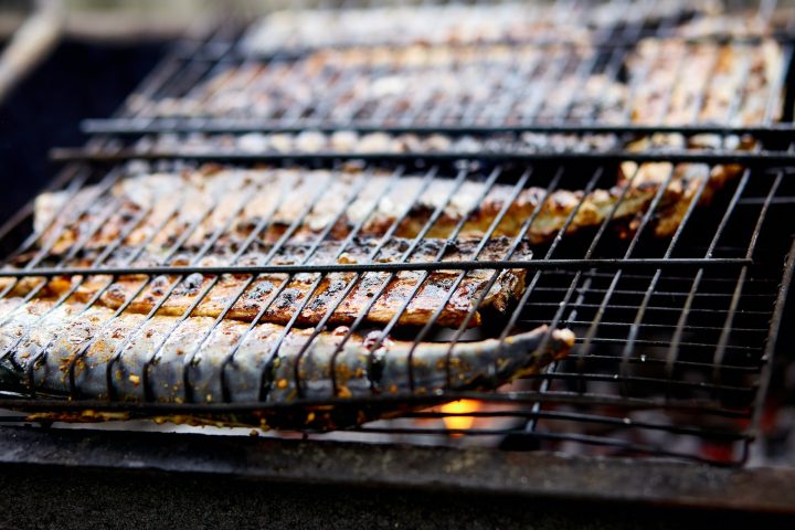 Grilled fish mackerel, cooked on the grill in the open air flow