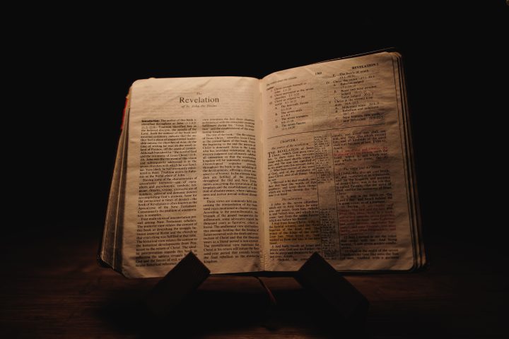 Old Bible book open on the book of Revelation