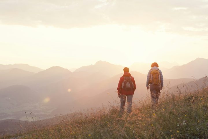 Austria, Tyrol, couple hiking at Unterberghorn at sunrise