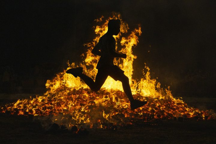 Summer solstice celebration jumping into the fire. Burning flames