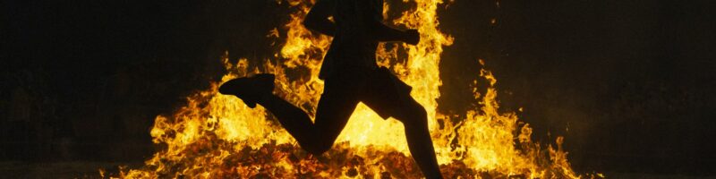 Summer solstice celebration jumping into the fire. Burning flames