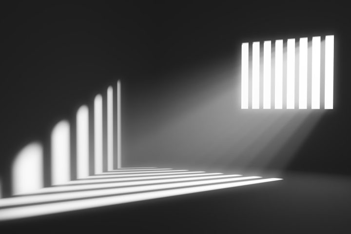 Light behind prison cell bars. Jail punishment and imprisonment