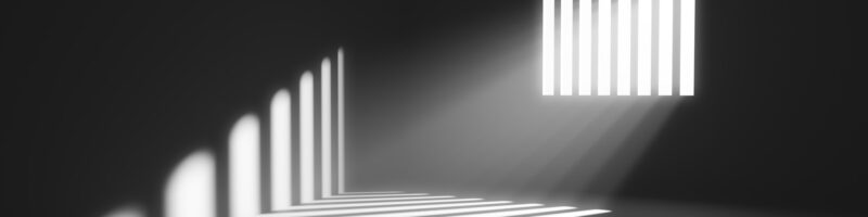 Light behind prison cell bars. Jail punishment and imprisonment