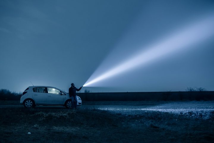 Man and Dog Searching with Flashlight in Outdoor