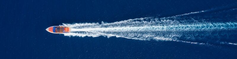 Fast boat at the sea in Bali, Indonesia. Aerial view of luxury floating boat