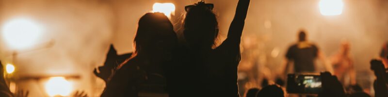 Two woman in the crowd at a music festival