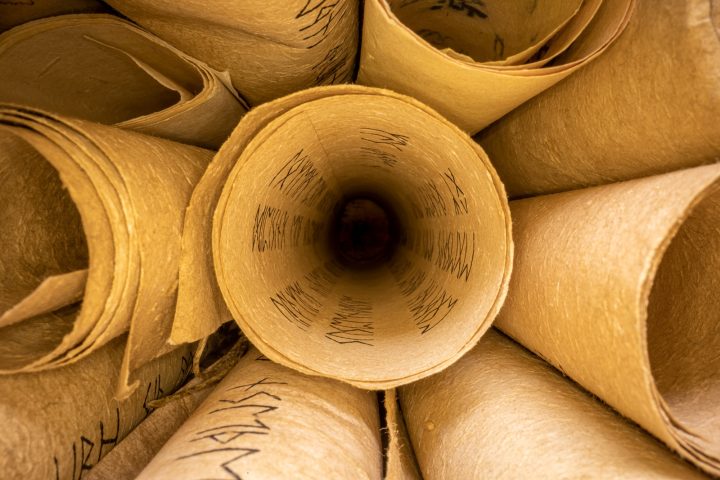 Old scribe library. Retro futhpak scrolls stacked on a pile.