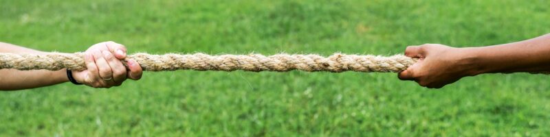 Closeup of hand pulling the rope in tug of war game