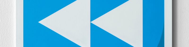 Blue rewind button music icon