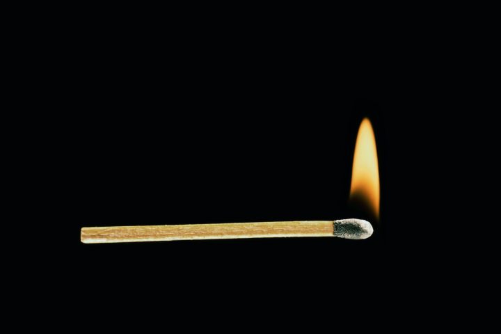 Burning match on a black background